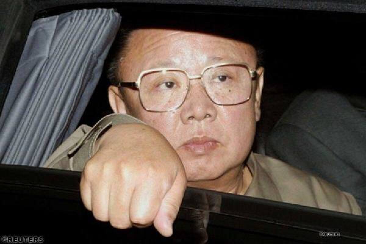 Kim Čong-il pozerajúci z okna svojej limuzíny.