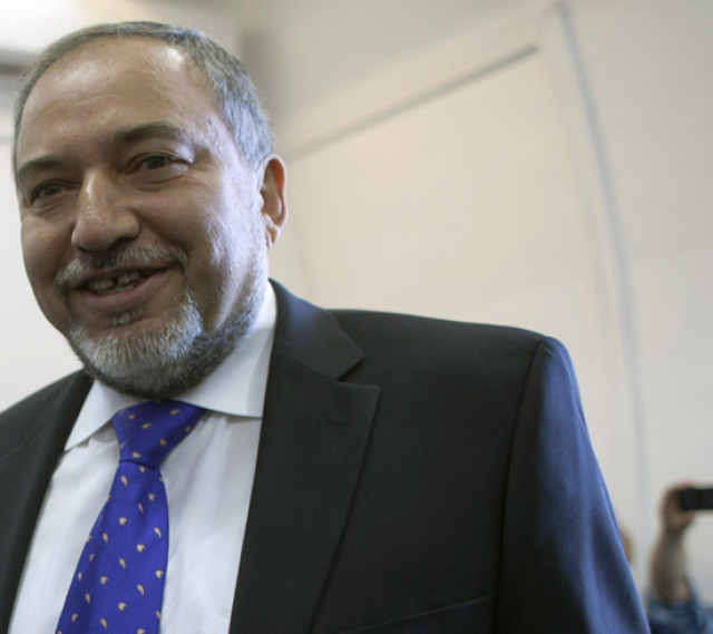 Former Israeli Foreign Minister Avigdor Lieberman arrives in the courtroom to hear the verdict in his trial on November 6, 2013 at the Magistrates Court in Jerusalem. Lieberman, who was charged with fraud and breach of trust, was unanimously acquitted by 