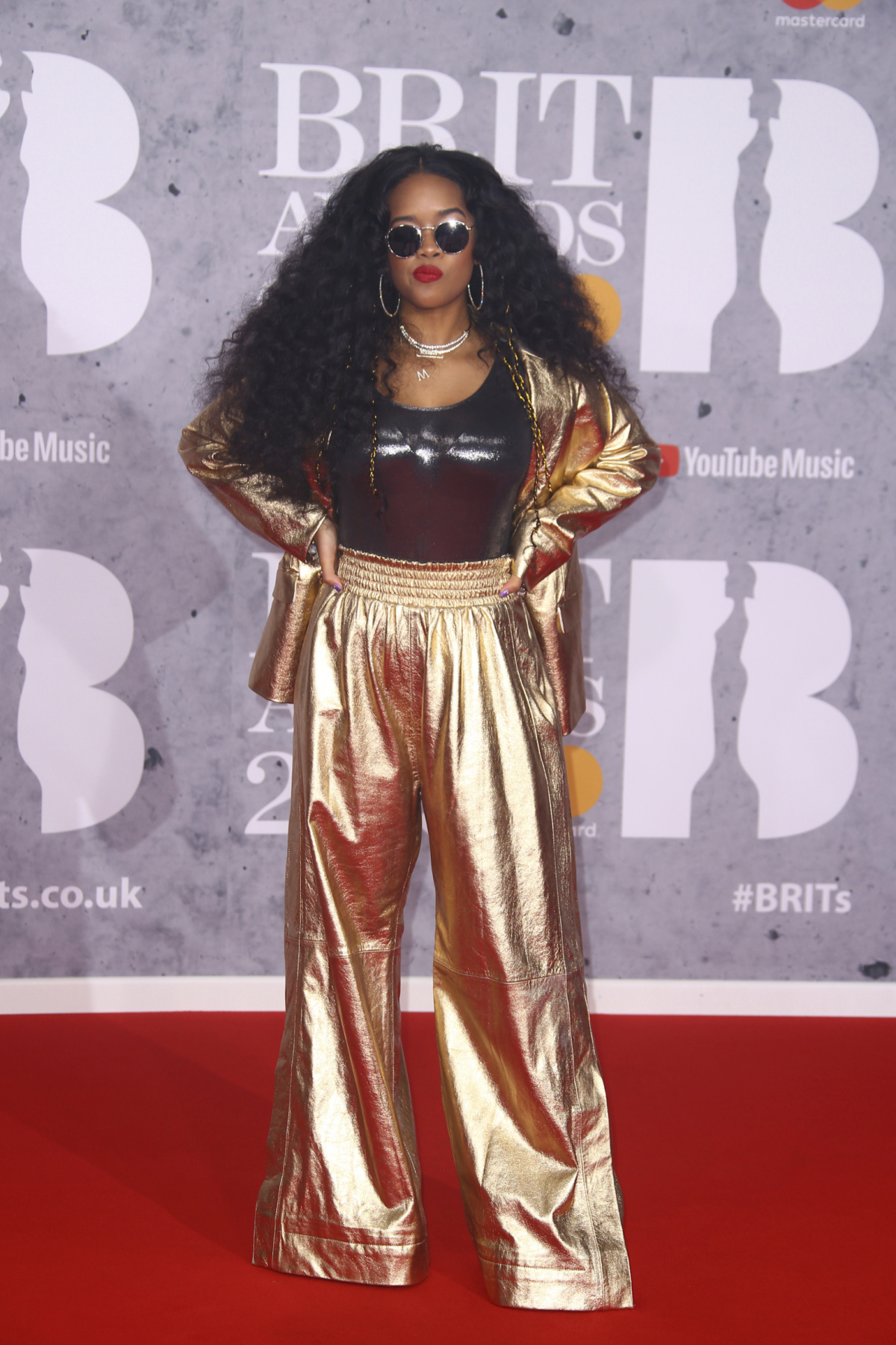 Speváčka H.E.R. pózuje fotografom pri príchode na Brit Awards 2019.