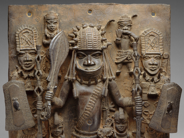 PLAQUE WARRIOR AND ATTENDANTS, 16th-17th c., Nigeria, Africa, Court of Benin, sculpture, cast brass. This work hung on the exterior of the royal palace in Benin City. In center is a warrior chief, fla