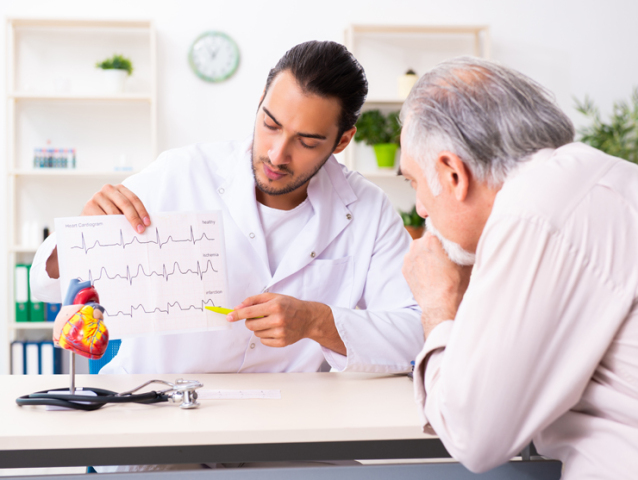 Old man visiting young male doctor cardiologist