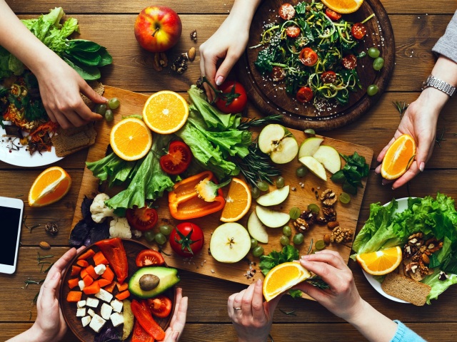 Healthy food dinner table. Women at home together, eating fruits and vegetables, top view, flat lay, crop