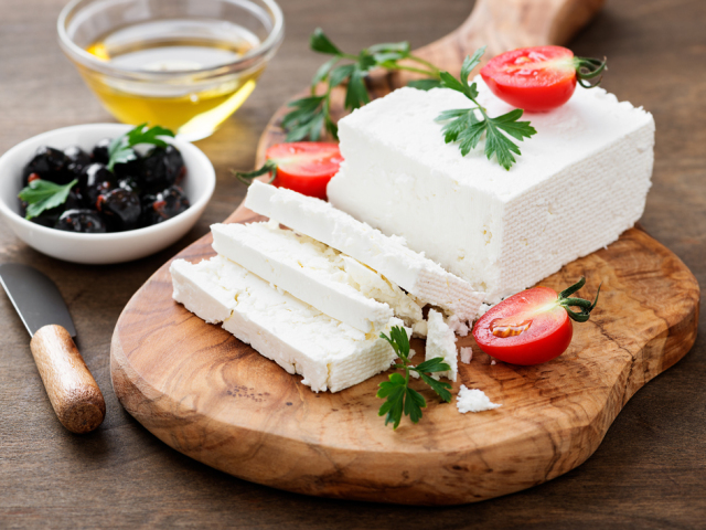 Sliced Feta cheese with herbs and olive oil.