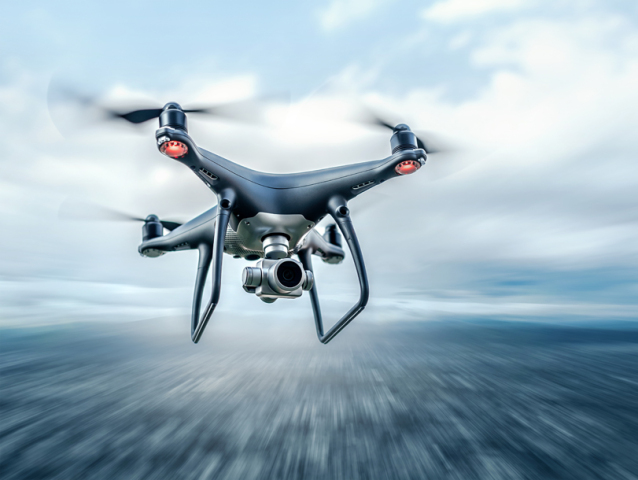 Dark drone in flight over the city.
