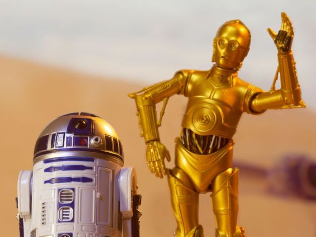 MAY 13 2020: Recreation of a scene from Star Wars A New Hope depicting droids C-3PO and R2D2 on the desert planet of Tatooine with escape pod - Hasbro action Figure