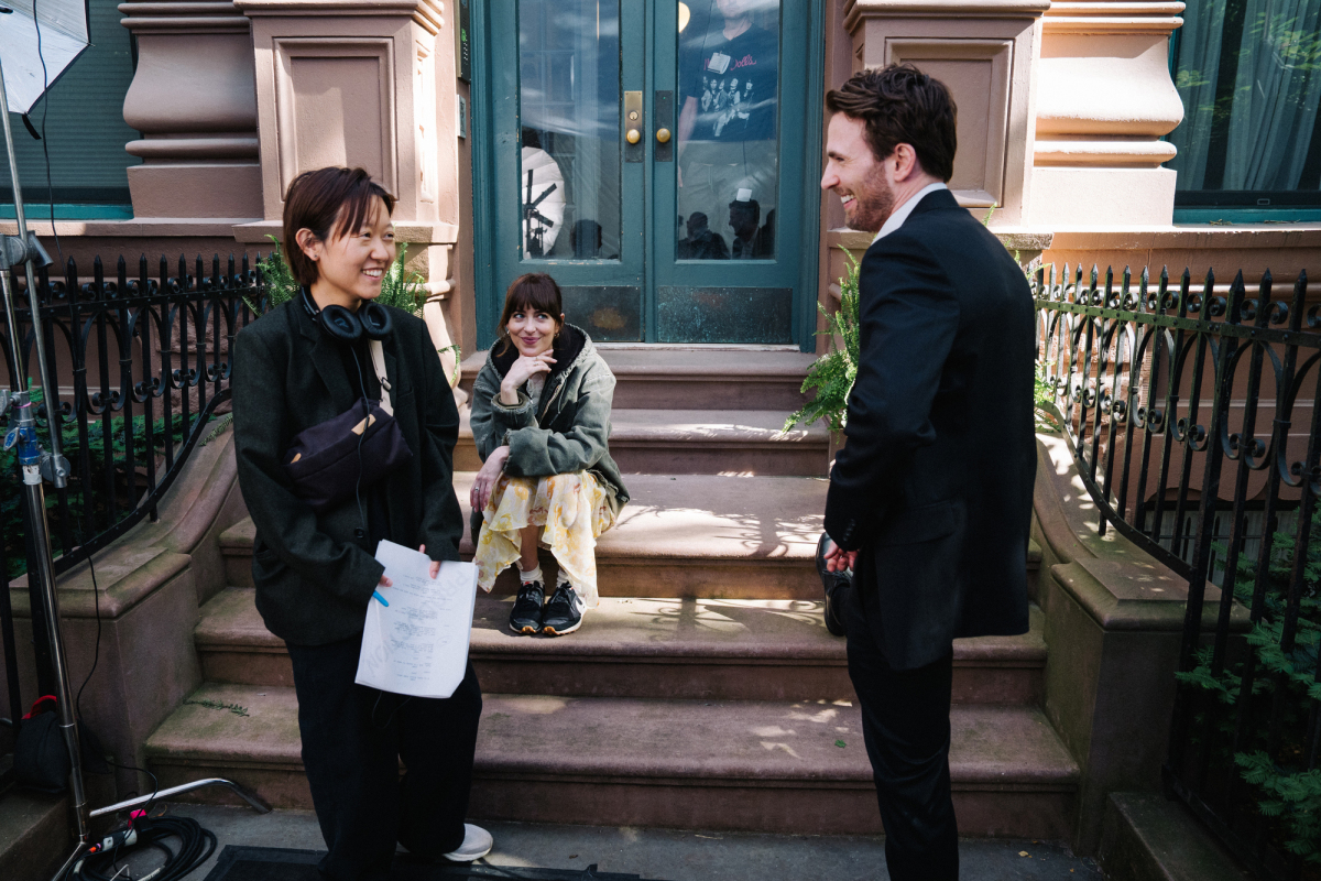 Dakota Johnson, Chris Evans and director Celine Song on the set of The Materialists.